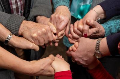 Menschen halten sich fest an den Händen